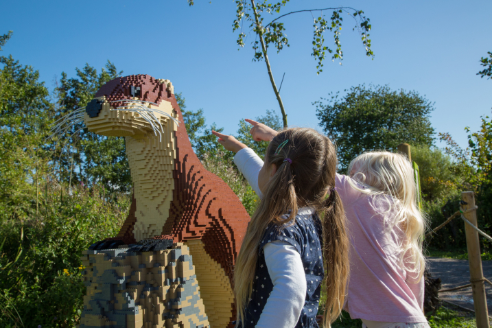 Picture shows two children pointing at a giant Lego otter at WWT Martin Mere